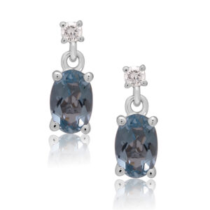 A pair of 18ct white gold oval shaped aquamarine and round brilliant cut diamond set drop earrings, with a post and butterfly fastening for pierced ears.
