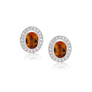A pair of 14ct white gold oval shaped citrine and round brilliant cut diamond set cluster stud earrings, with a post and butterfly clip fastening for pierced ears.