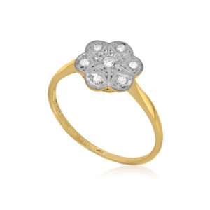 An early 20th century period 18ct yellow gold and platinum topped diamond flower cluster ring featuring a central brilliant cut diamond and outer eight cut diamonds.