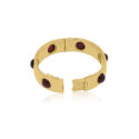 Early 20th Century, 18ct Yellow Gold Garnet Bangle An 18ct yellow gold, hinged bangle set with six evenly spaced round cabochon cut red garnets, with French control marks featured on the tongue.