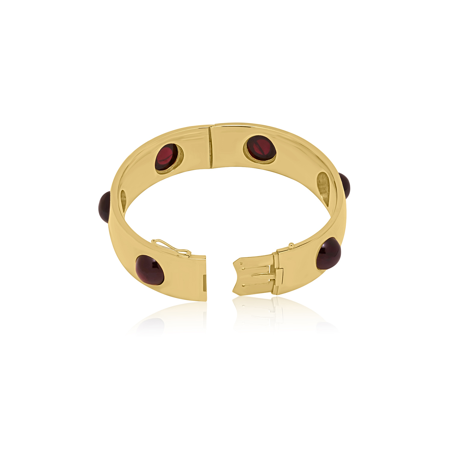 Early 20th Century, 18ct Yellow Gold Garnet Bangle An 18ct yellow gold, hinged bangle set with six evenly spaced round cabochon cut red garnets, with French control marks featured on the tongue.