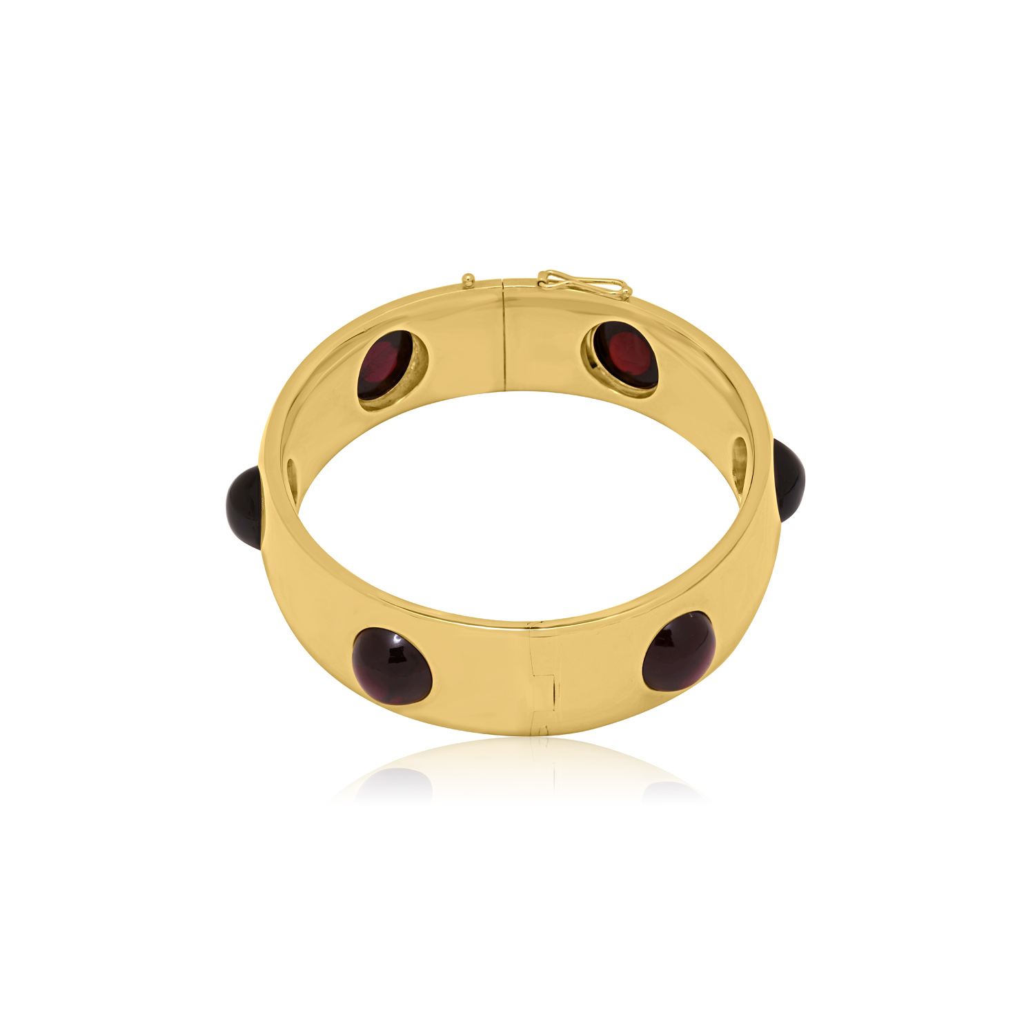 Early 20th Century, 18ct Yellow Gold Garnet Bangle An 18ct yellow gold, hinged bangle set with six evenly spaced round cabochon cut red garnets, with French control marks featured on the tongue.