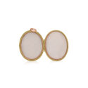 A 9ct rose gold oval shaped locket engraved with leaf and floral designs. Hallmarked Chester 1917.