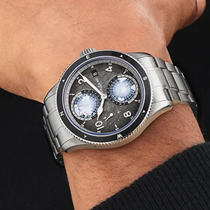 A Montblanc stainless steel watch with a black dial and bezel on a man's wrist.