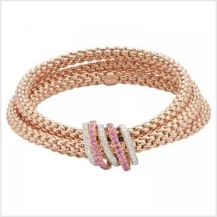 A rose and white gold triple bracelet with pink sapphires and diamonds, on a white background.