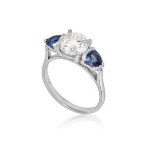New platinum, diamond and sapphire ring, angled and upright.